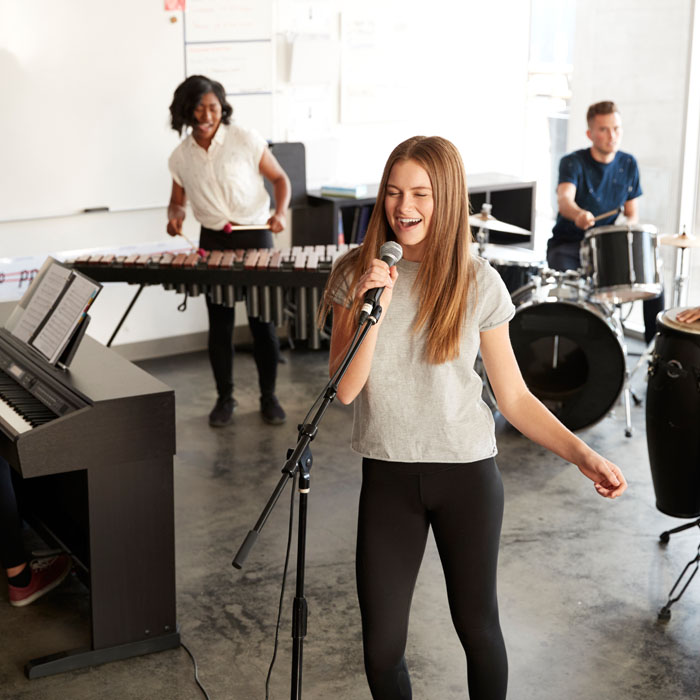 students at performing arts school playing in band WQBREU6